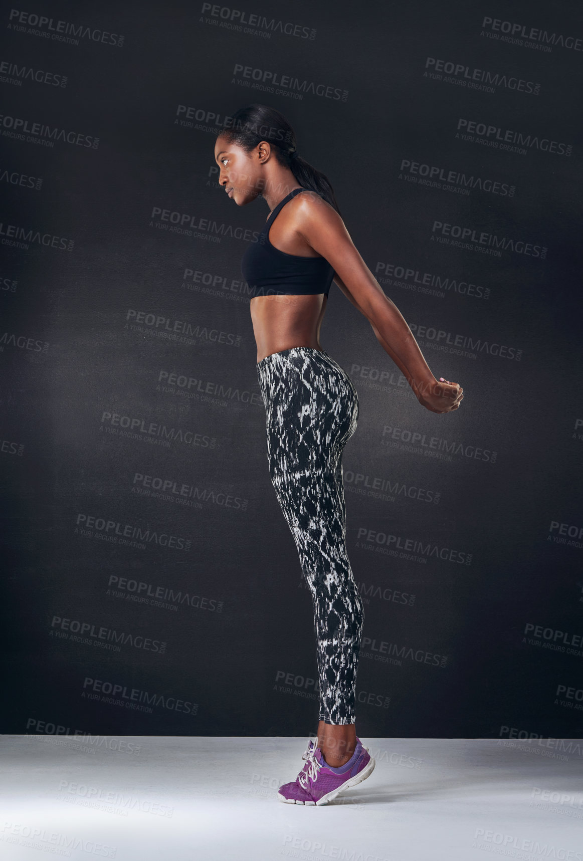 Buy stock photo Studio shot of a beautiful young woman working out against a black background