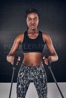 Buy stock photo Studio shot of a beautiful young woman working out against a black background