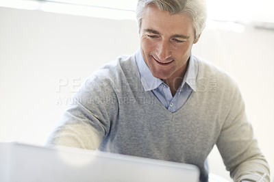 Buy stock photo Shot of a businessman at work in an office