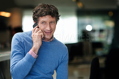 Buy stock photo Shot of a businessman using his cellphone at work in an office