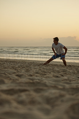 Buy stock photo Shot of a man doing yoga on the beach at sunset