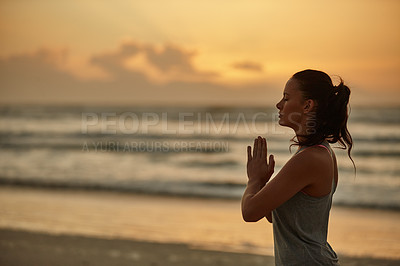 Buy stock photo Shot of a woman doing yoga on the beach at sunset