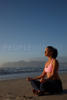 Buy stock photo Shot of a woman meditating on the beach