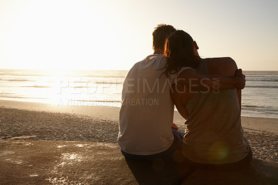 Buy stock photo Silhouette of a couple sitting beside each other at the beach