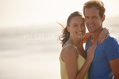 Buy stock photo Shot of an affectionate couple on the beach