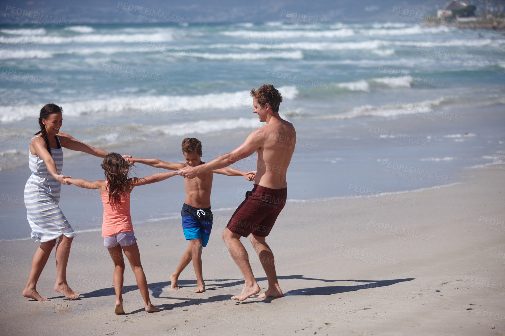 Buy stock photo Shot of a happy family being playful at the beach