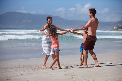 Buy stock photo Shot of a happy family being playful at the beach