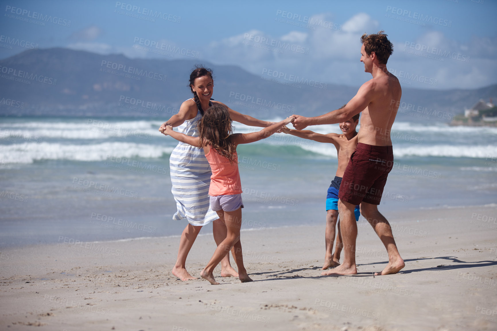 Buy stock photo Shot of a happy family being playful at the beach