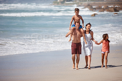 Buy stock photo Shot of a family walking along the beach
