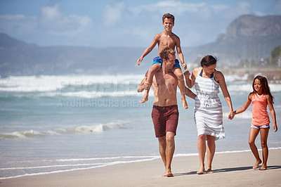 Buy stock photo Shot of a family walking along the beach