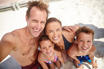 Buy stock photo A happy family taking a selfie at the beach