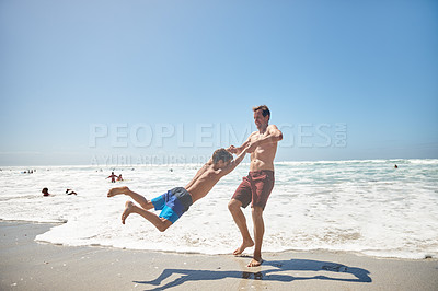 Buy stock photo Shot of a father and his son having fun at the beach