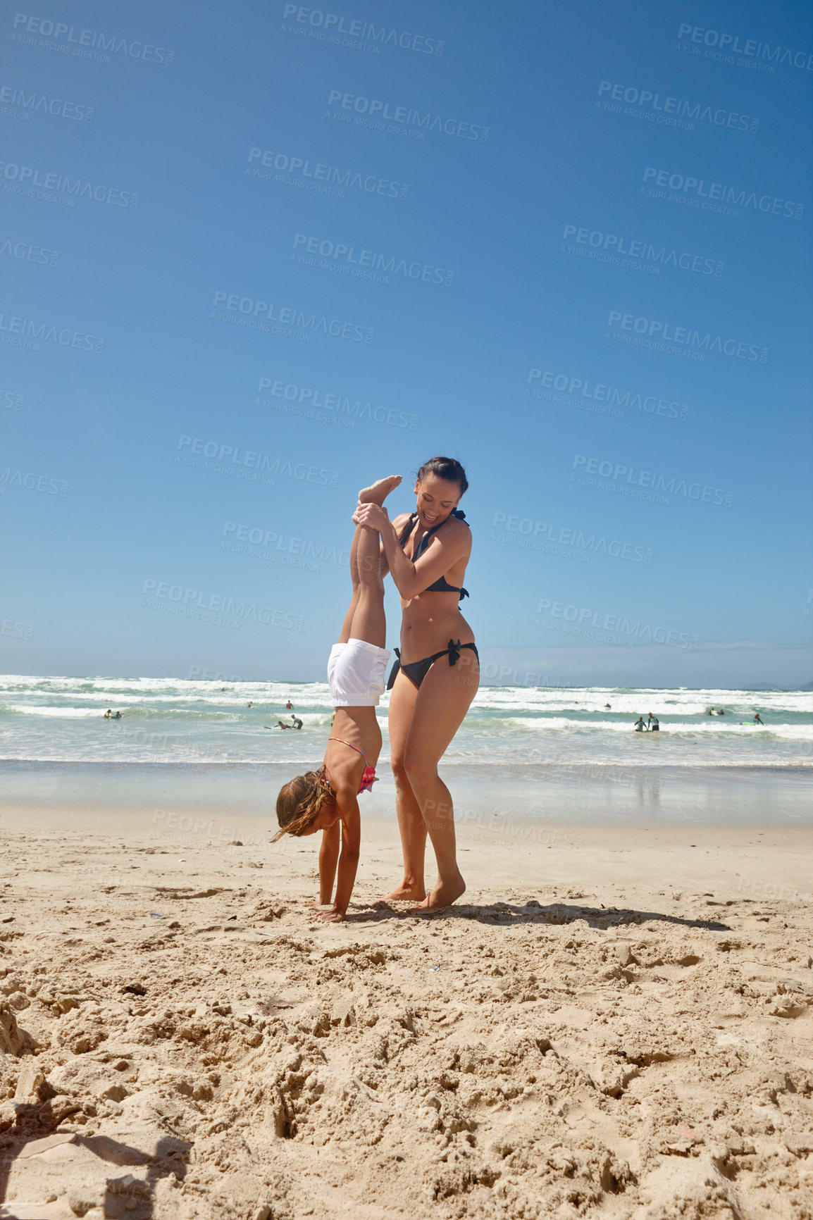 Buy stock photo Shot of a mother and daughter having fun at the beach