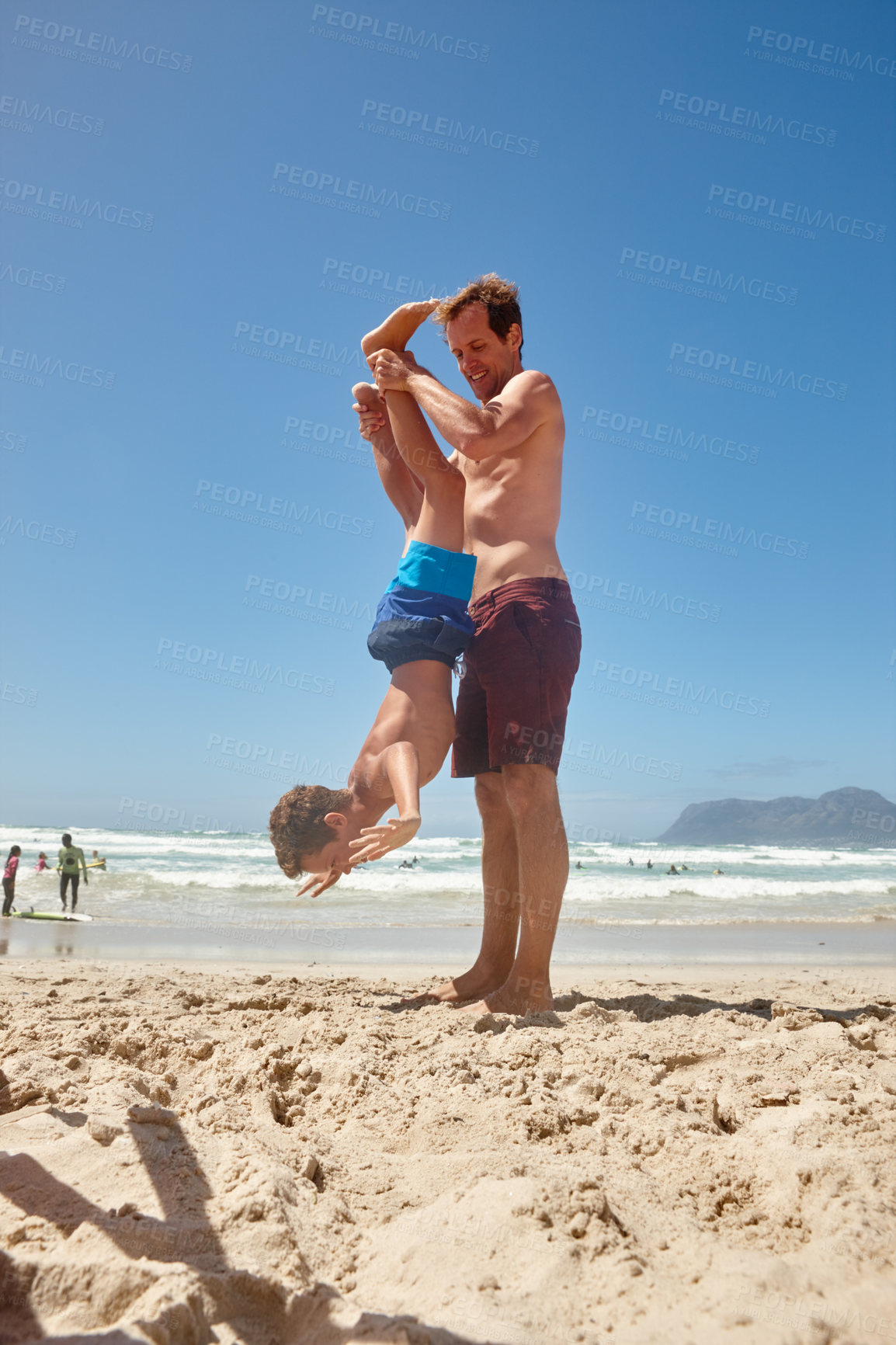 Buy stock photo Shot of a father and his son having fun at the beach