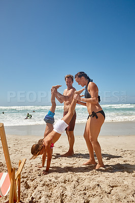 Buy stock photo Shot of a happy family having fun together at the beach
