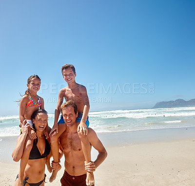 Buy stock photo Portrait of a happy family of four at the beach