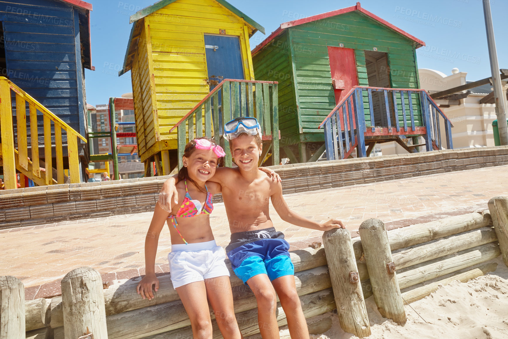 Buy stock photo Portrait of a brother and sister sitting together at the beach