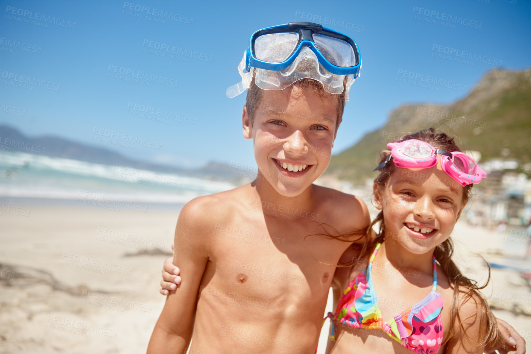 Buy stock photo Portrait of a brother and sister standing together on the beach