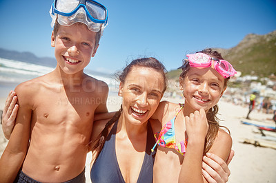 Buy stock photo Portrait of a mother standing with her two children on the beach