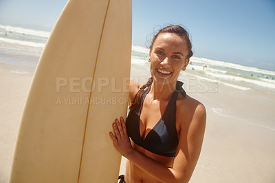 Buy stock photo Portrait of a woman standing with her surfboard on the beach