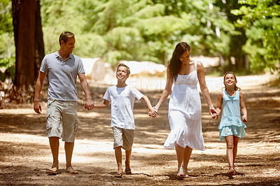 Buy stock photo Shot of a happy family spending quality time together in the forest