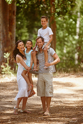 Buy stock photo Shot of a happy family spending quality time together in the forest