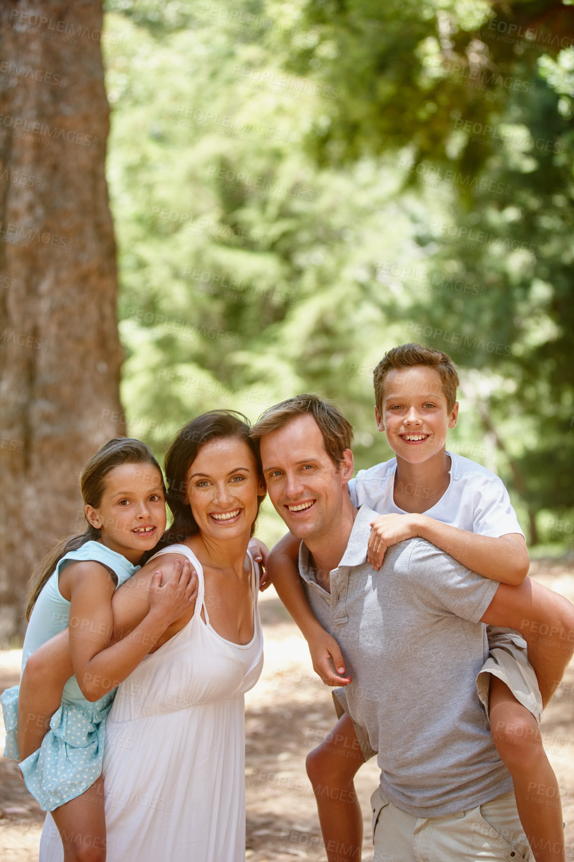 Buy stock photo Shot of a happy family spending quality time together in the forest