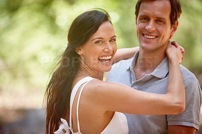 Buy stock photo Shot of a happy couple enjoying a carefree day together in the forest