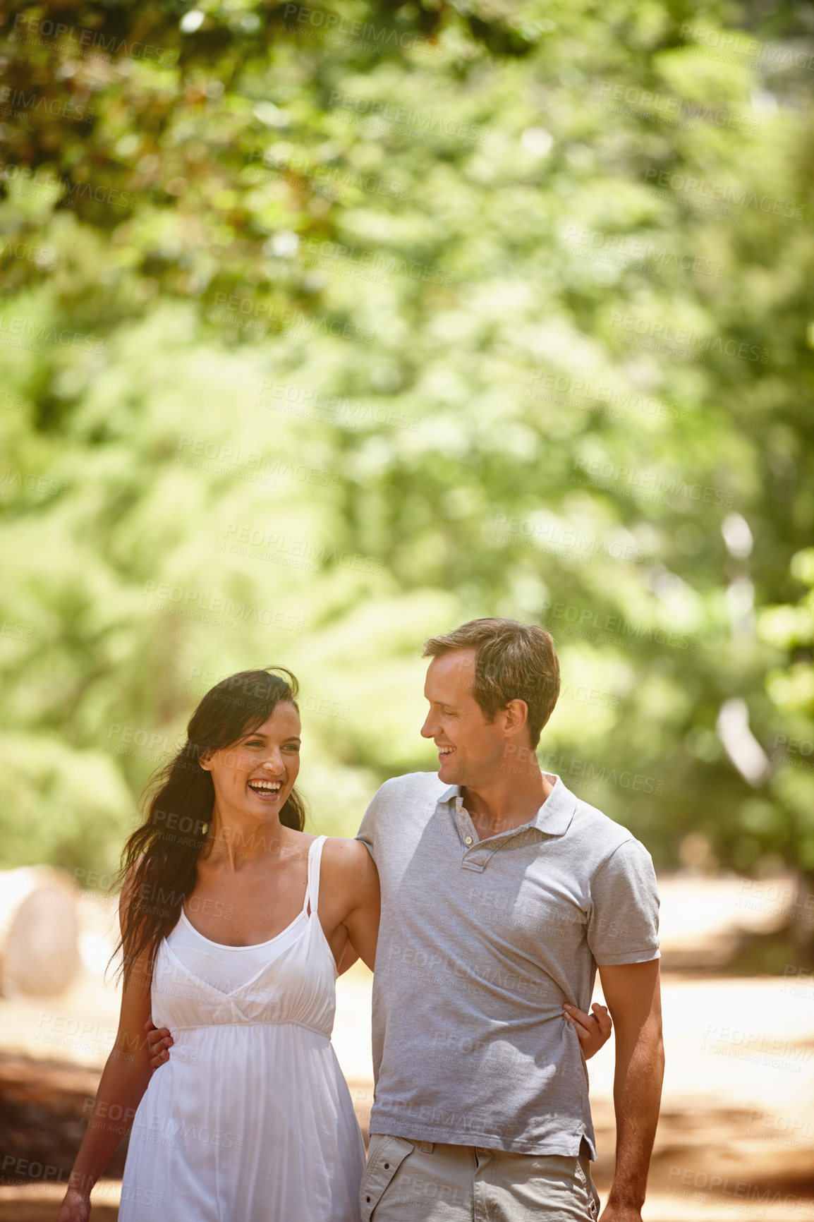 Buy stock photo Shot of a happy couple enjoying a carefree day together in the forest