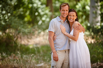 Buy stock photo Shot of a happy couple enjoying a carefree day together in the forest