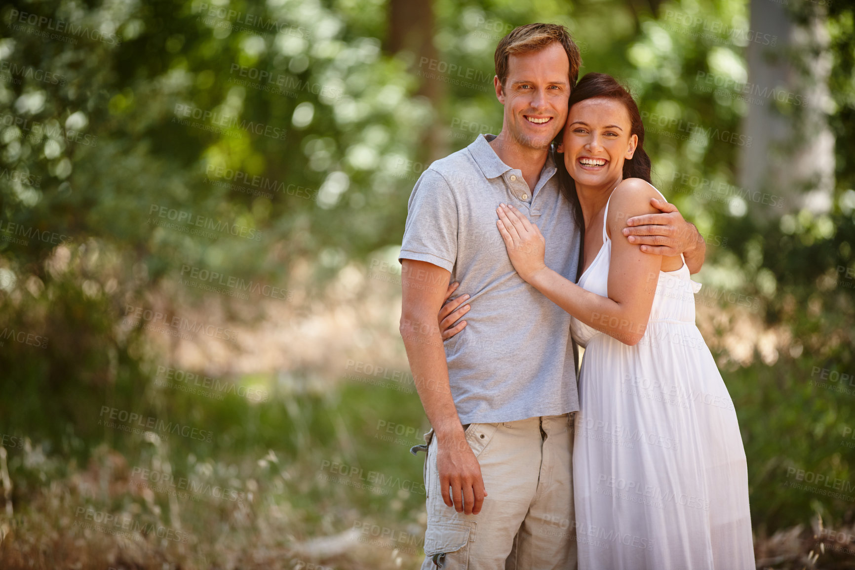 Buy stock photo Shot of a happy couple enjoying a carefree day together in the forest