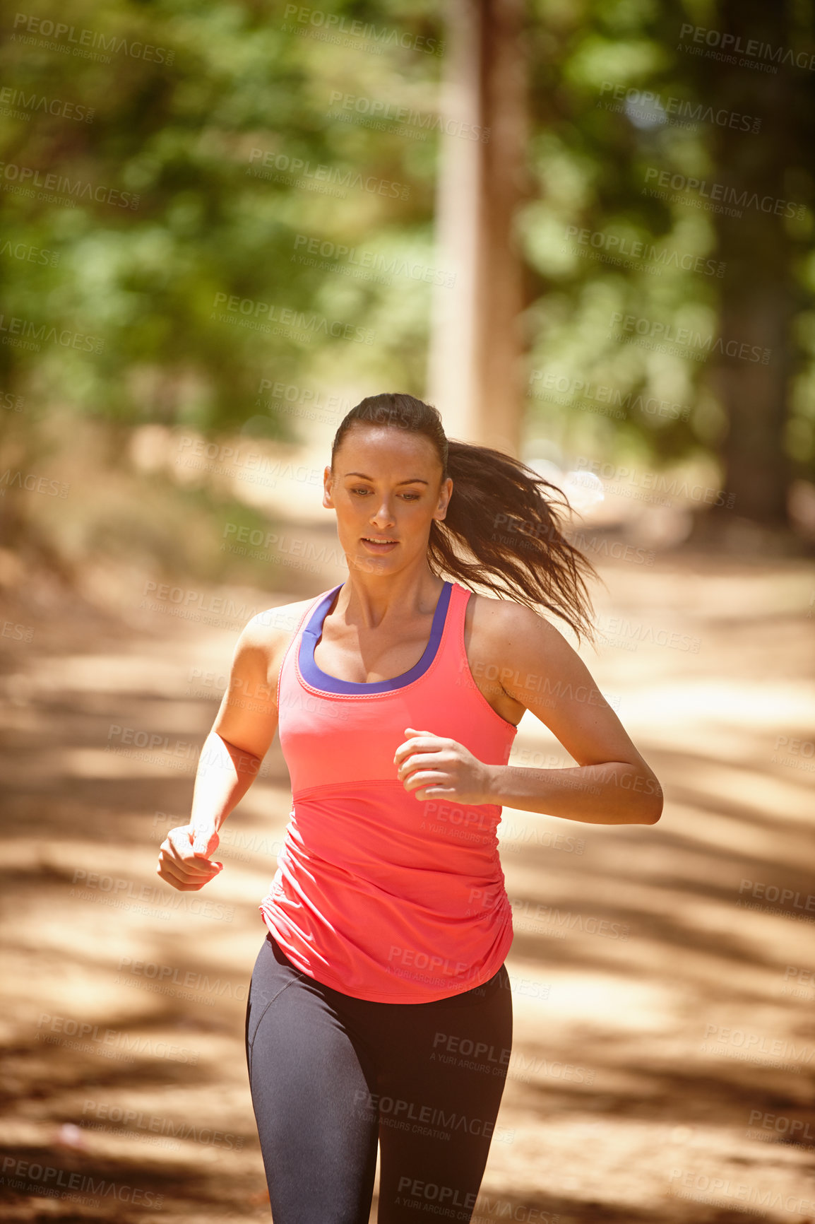 Buy stock photo Cropped shot of an attractive woman jogging in a forest