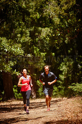 Buy stock photo Full length shot of a couple jogging in the forest