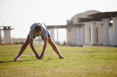Buy stock photo Shot of a man doing stretches before his workout