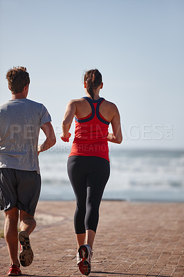Buy stock photo Shot of a young couple exercising outdoors