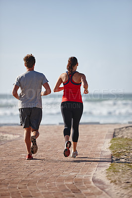 Buy stock photo Shot of a young couple exercising outdoors