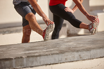 Buy stock photo Cropped shot of a couple stretching before their workout