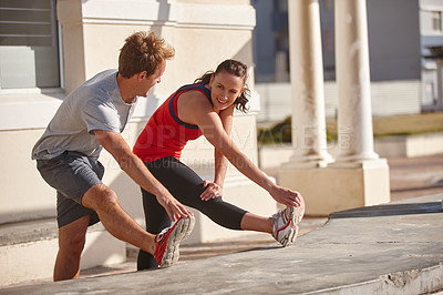 Buy stock photo Cropped shot of a couple stretching before their workout