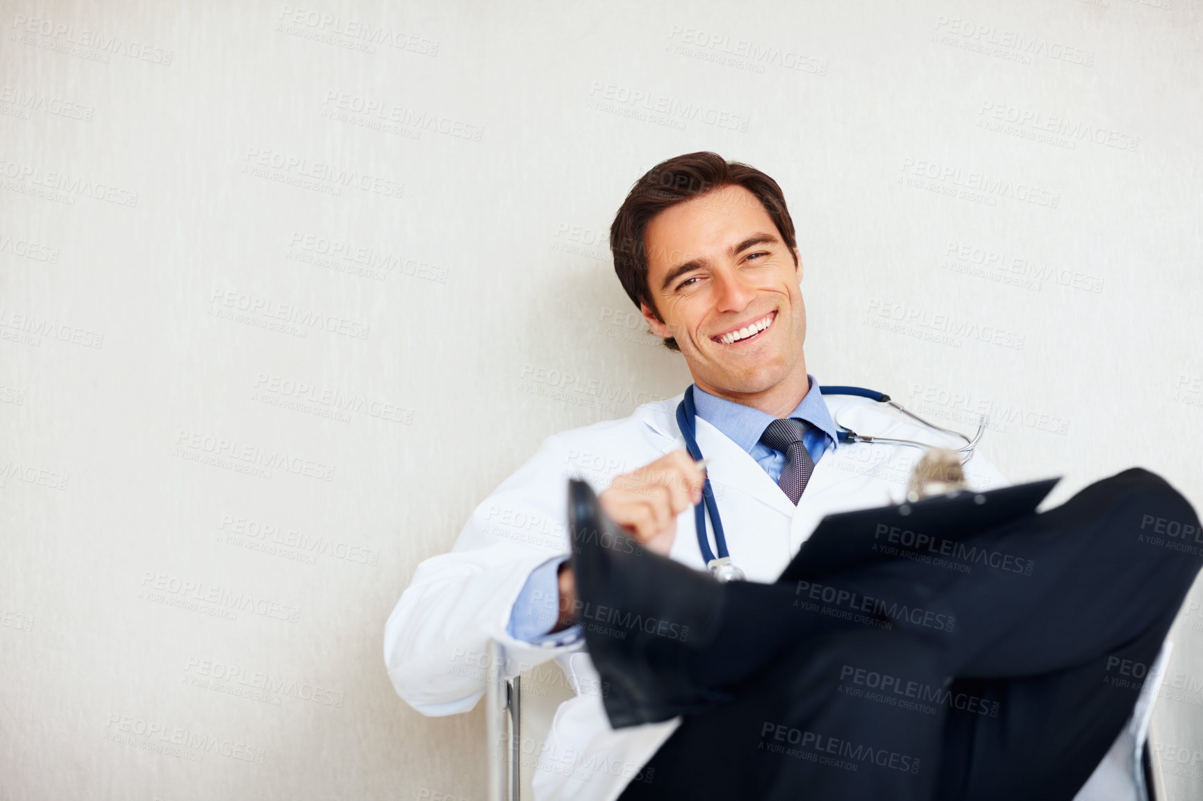 Buy stock photo Portrait, smile and relax man, doctor or surgeon happy for medical support, hospital services or career experience. Mockup wall space, cardiology and professional expert for clinic healthcare work