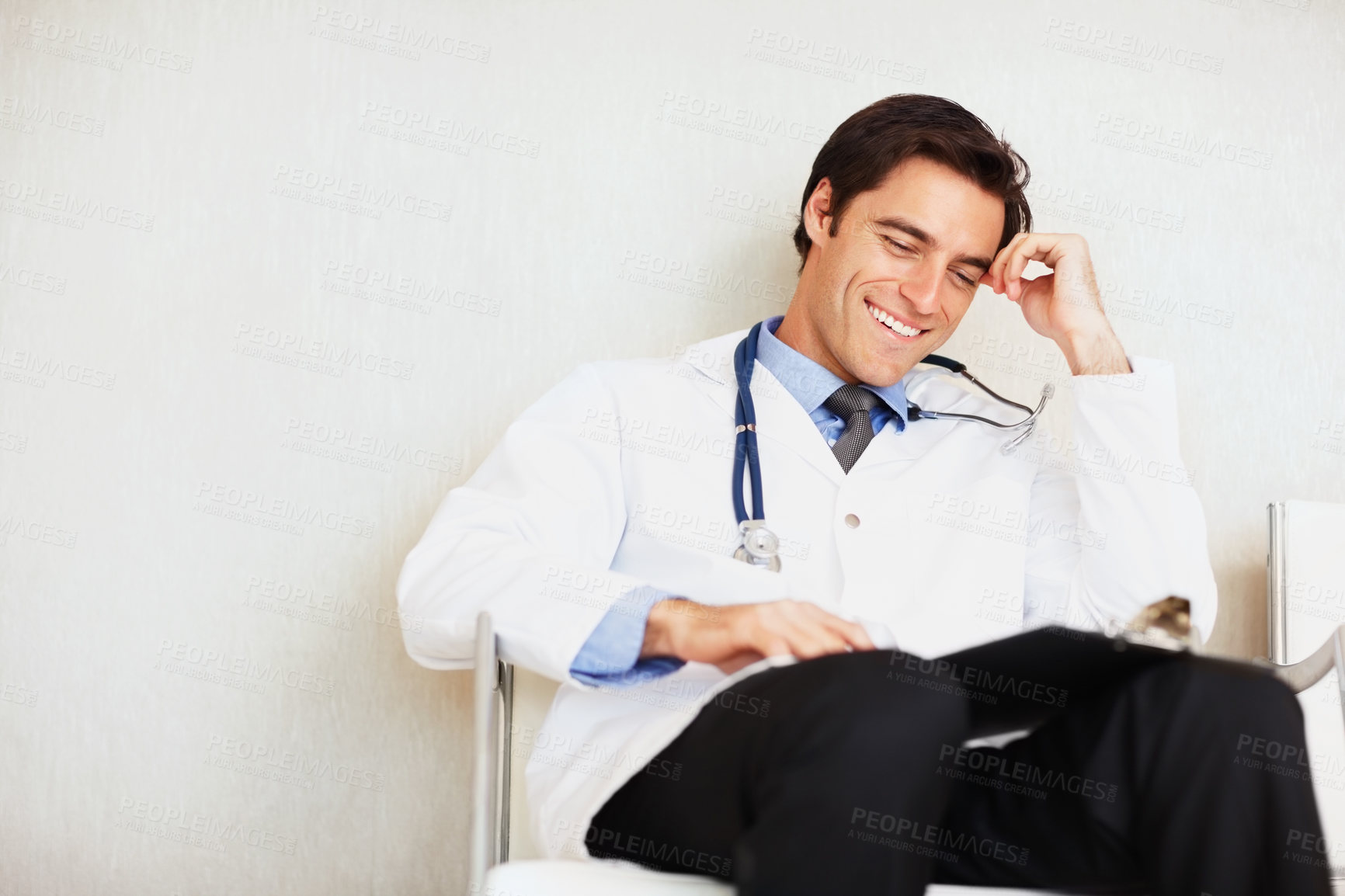 Buy stock photo Clipboard, happiness and relax man, doctor or surgeon reading medical report, hospital info or medicine notes. Mockup wall space, checklist and professional expert check clinic healthcare paperwork