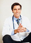 Smiling confident young doctor with stethoscope looking at you