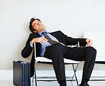 Bored business man sleeping on chair with copyspace