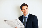 Young business man reading a newspaper with copyspace