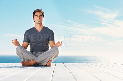 Buy stock photo Yoga, blue sky and relax man meditate for spiritual mindset healing, chakra energy balance or outdoor summer freedom. Mockup mindfulness space, beach patio and yogi peace, calm and zen for wellness
