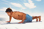 Masculine man exercising on a porch on a bright sunny day