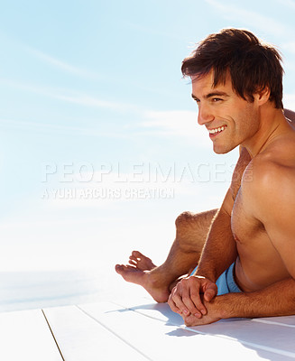 Buy stock photo Face, relax and shirtless man on a deck with a view of the water in summer while on holiday or vacation. Smile, ocean or sky and the body of a young tourist tanning outdoor on a pier with space