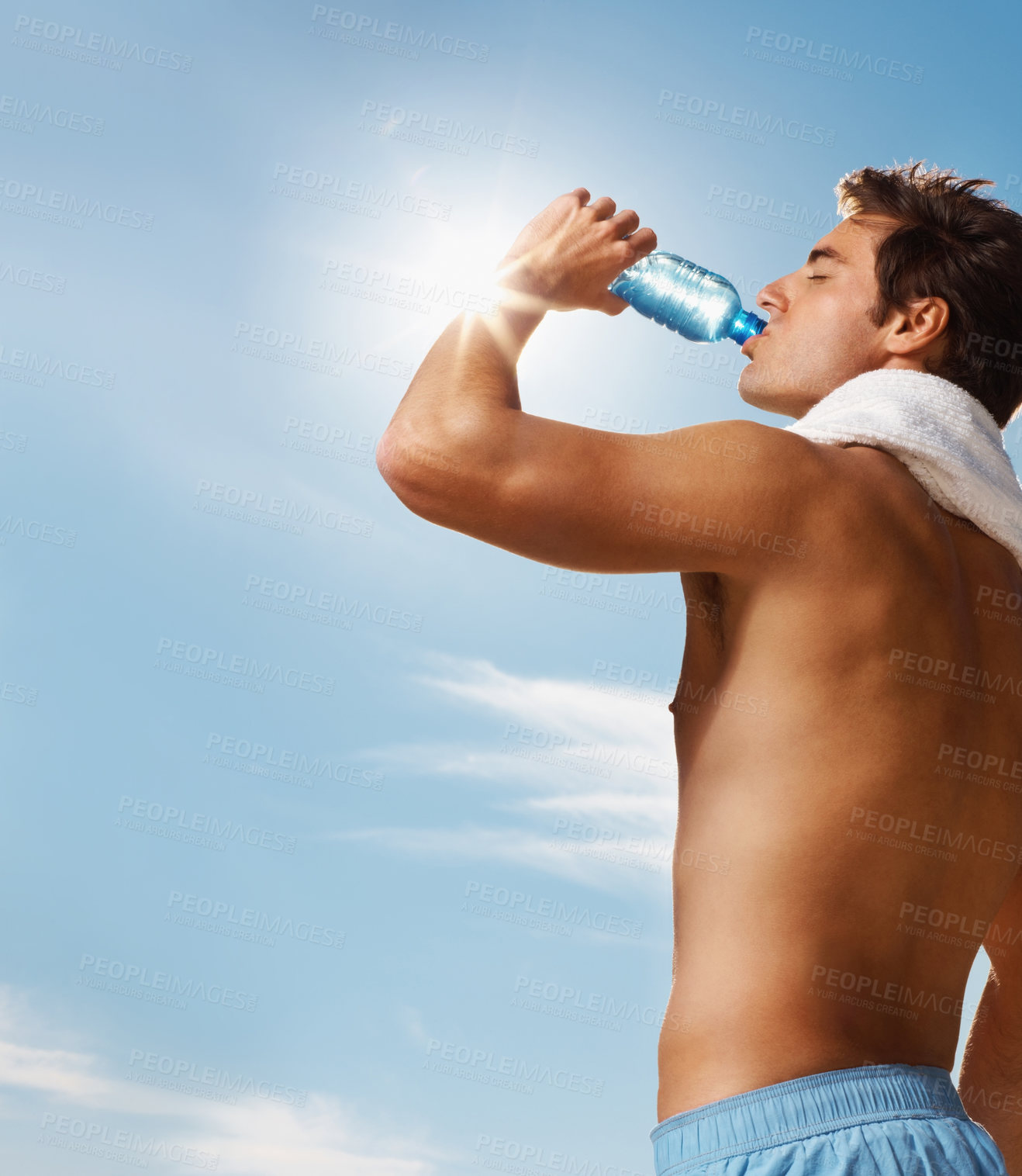 Buy stock photo Man, drinking water and bottle with towel for workout, health body and fitness and vacation. Model, thirsty and natural glow with h2o drink for hydration and post cardio exercise by sky background