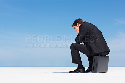 Buy stock photo Depression, sky and business man sad, burnout or stress over corporate mistake, company disaster or agency fail. Mental health risk, mockup space and back of professional person sitting on briefcase
