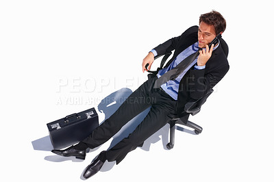 Buy stock photo Business man, relax and phone call of a corporate professional in a chair with communication in studio. Worker, male employee and suit with mobile networking and white background with job and career