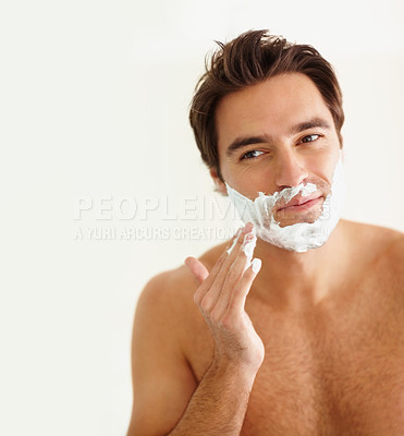 Buy stock photo Shaving, cream and face of happy man in morning, grooming routine and bathroom. Cosmetics, beauty and hand with hair removal, foam or person with self care in home for wellness of skin and body